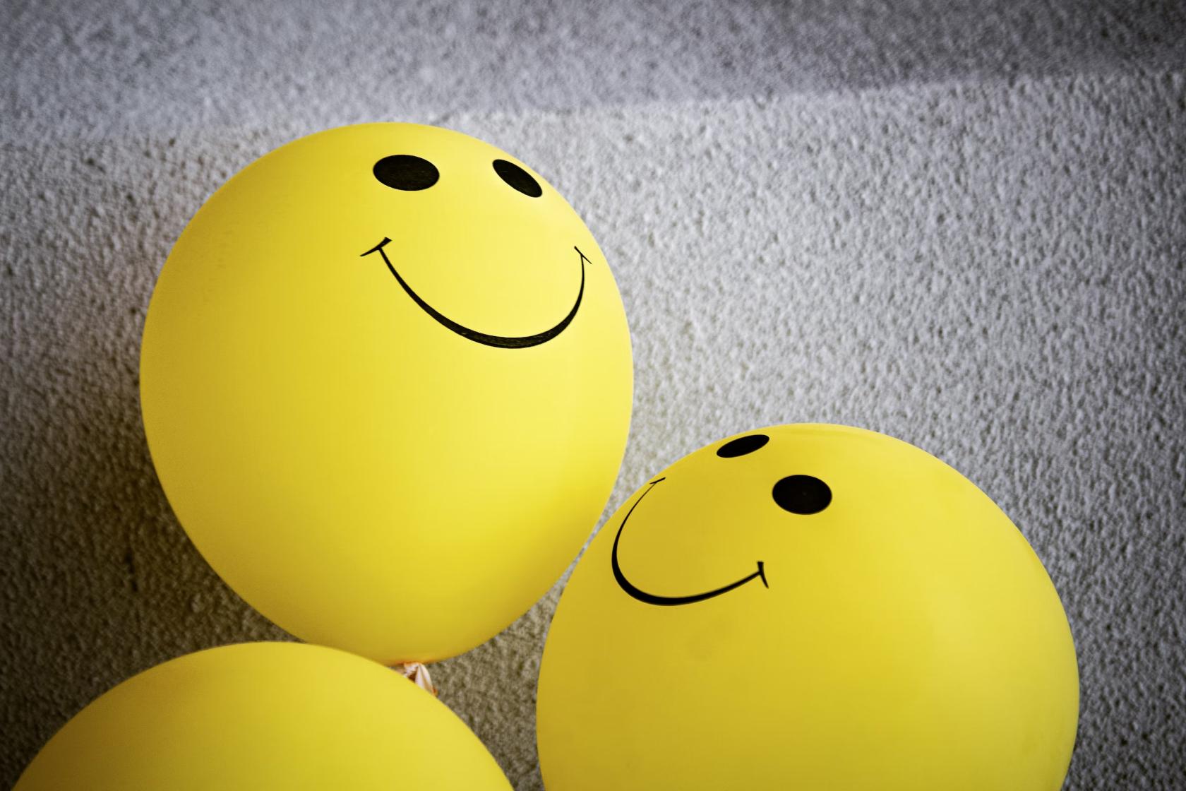 yellow balloons with smiles